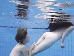 Enjoying a redhead underwater lesbian sex